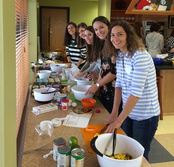 a group of ladies cooking together