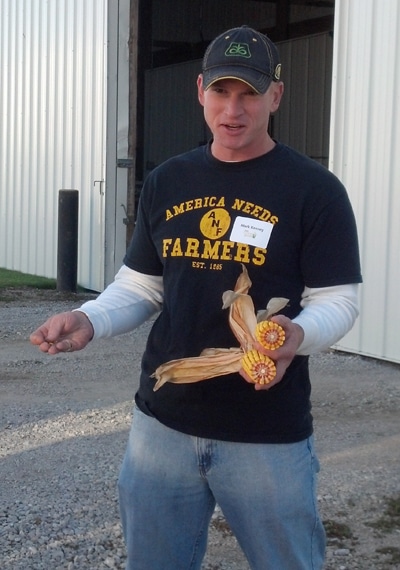 farm guy holding corn