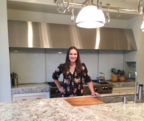 a woman standing at the counter in a test kitchen