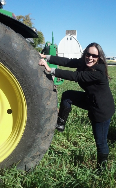 tractor with woman grabbing the tire
