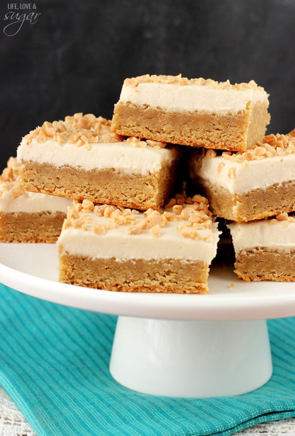 Frosted Maple Cookie Bars piled on a cake tray