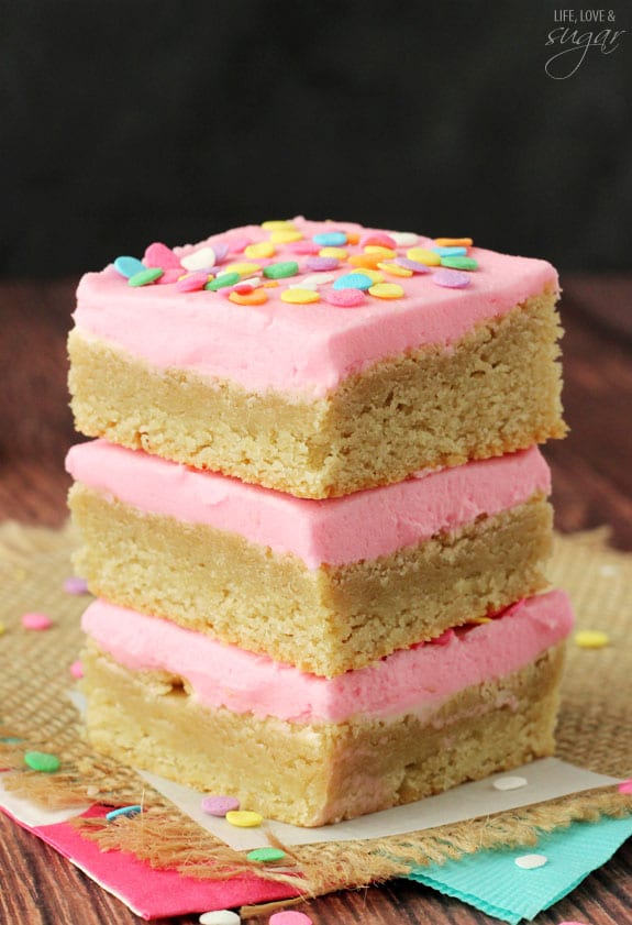 Pink Frosted Sugar Cookie Bars in a stack