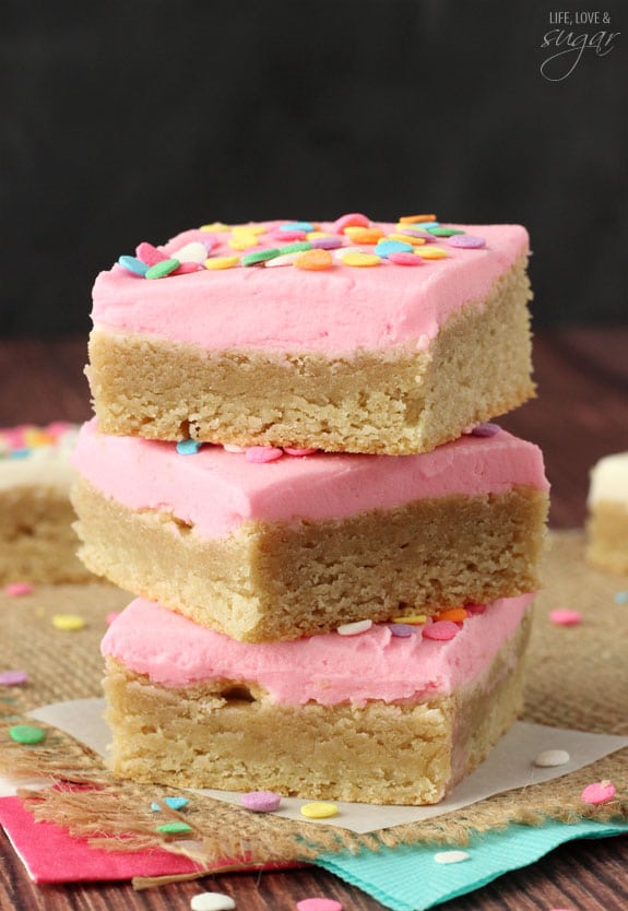 Pink Frosted Sugar Cookie Bars in a stack