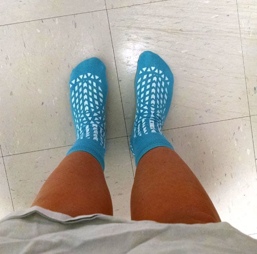 Looking down at Lindsay's feet in blue hospital socks