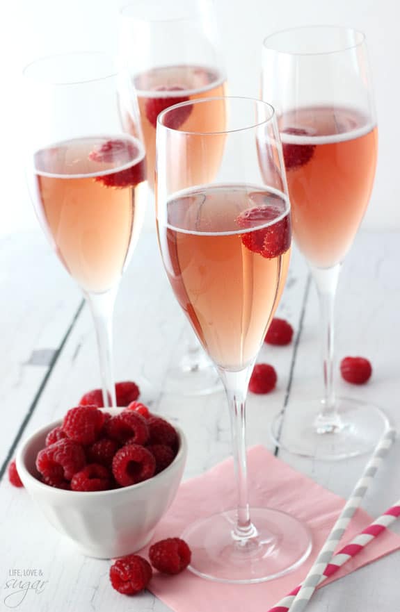 Black Raspberry Champagne Bellinis with a Bowl of Raspberries