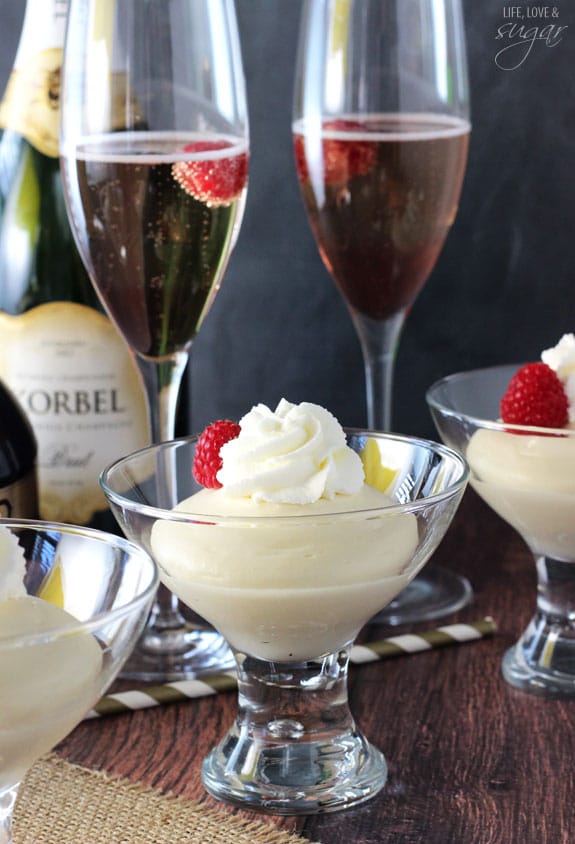 Champagne Mousse with whipped cream and raspberries in glass cups