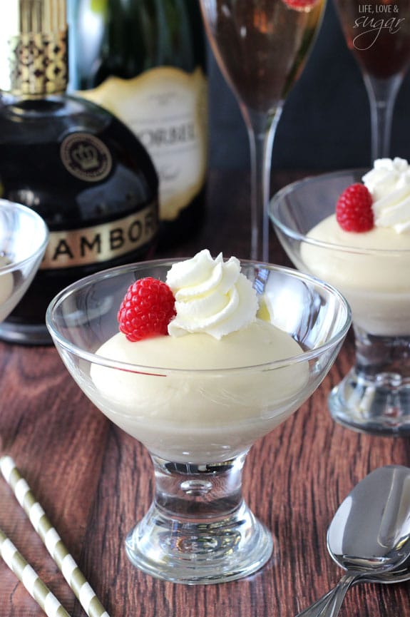 Champagne Mousse in glasses topped with raspberries and whipped cream