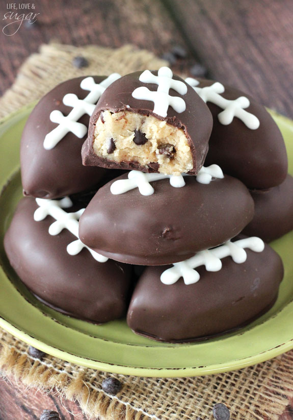 Eggless Chocolate Chip Cookie Dough Footballs on a green plate with a bite out of one
