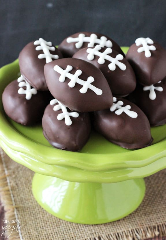 Eggless Chocolate Chip Cookie Dough Footballs on a green cake stand