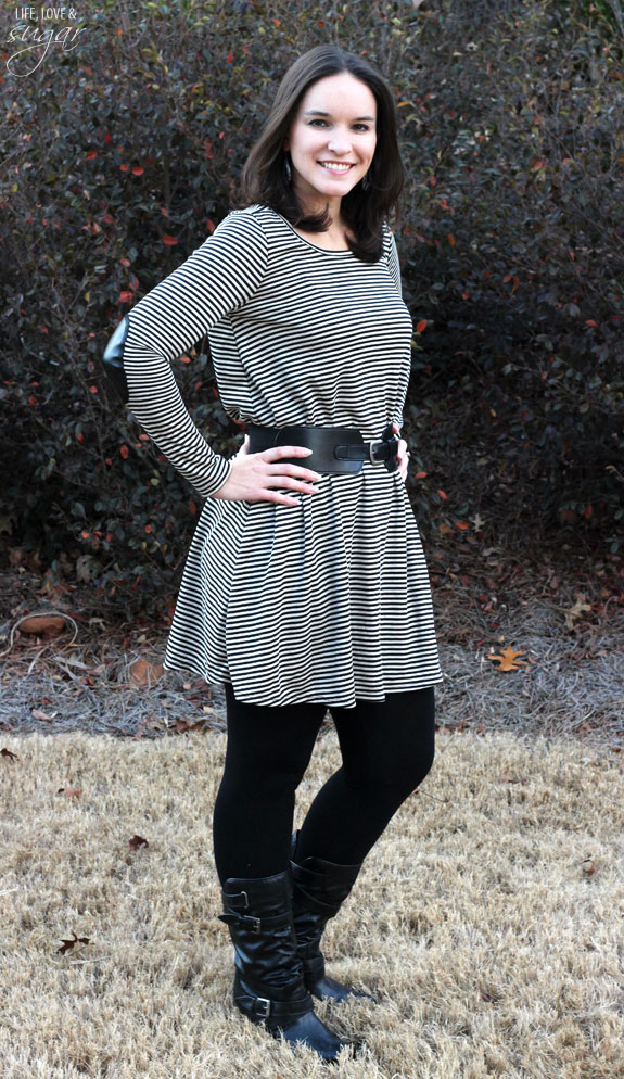 Author posing in a black and white striped dress with belt