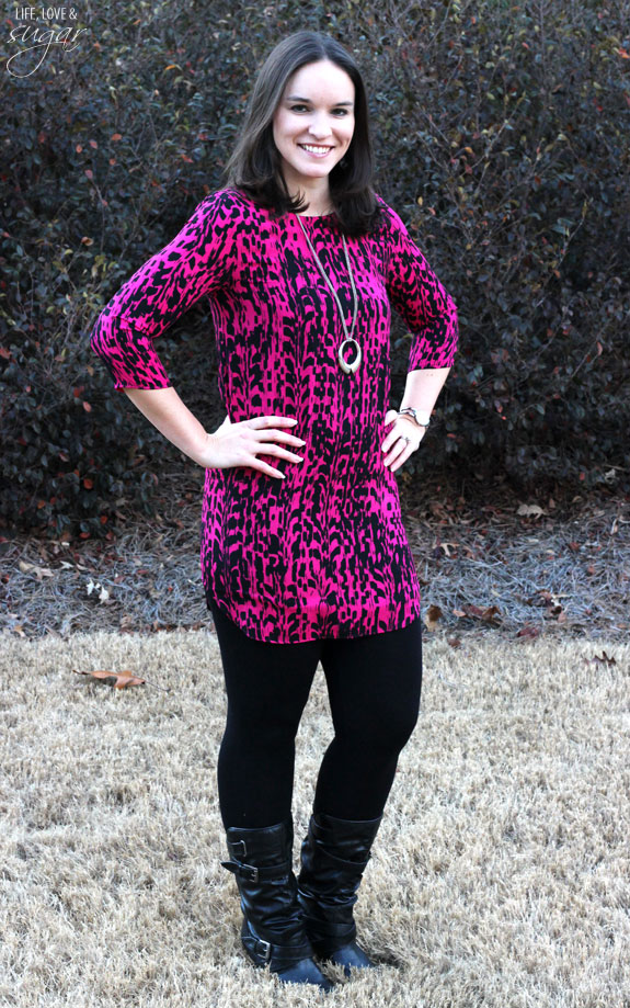 Author posing in a pink and black printed tunic top