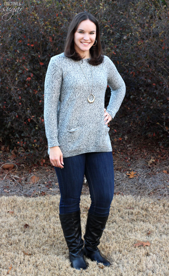 Author posing in a gray sweater