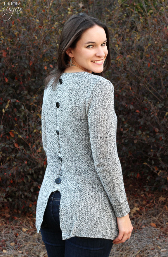 Author posing in a gray sweater