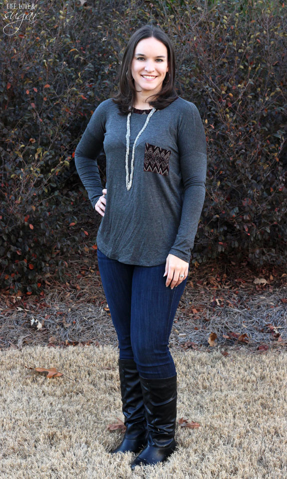 Author posing in a gray shirt and jeans