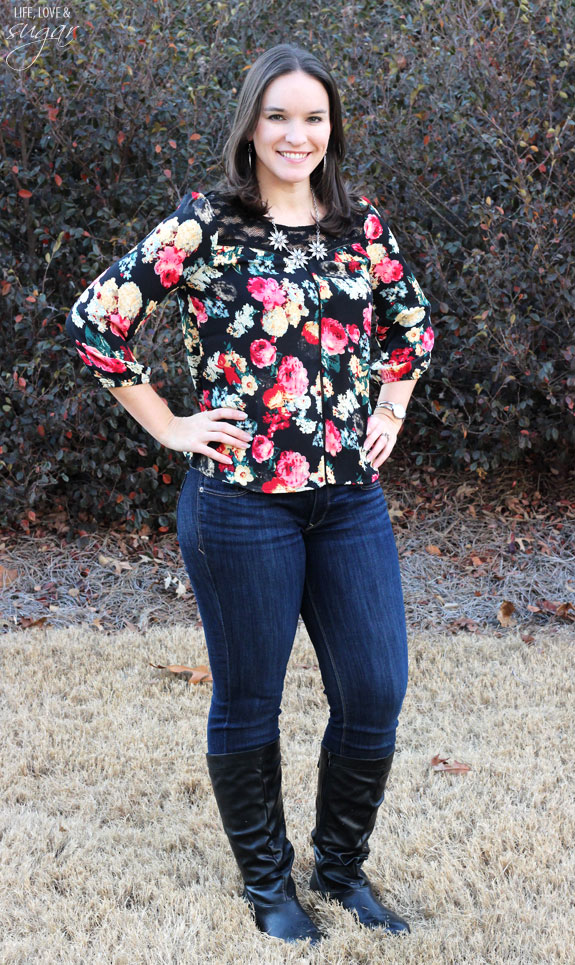Author posing in a floral top and jeans