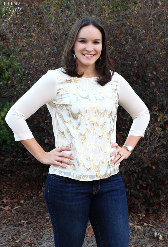 Author posing in a dressy cream and gold top