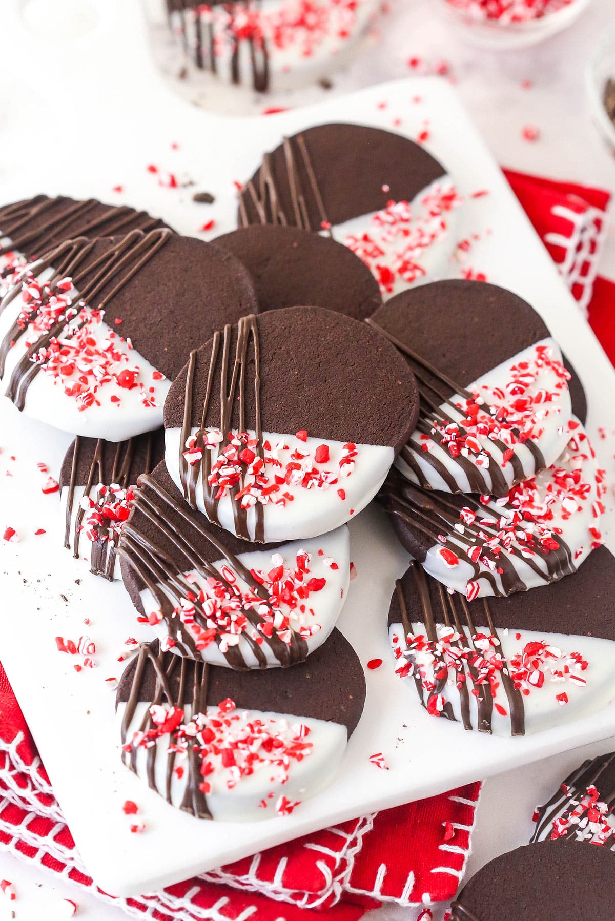Drizzled with chocolate and topped with crushed peppermint, these Peppermint Chocolate Shortbread Cookies are fun and festive. A plate of peppermint chocolate shortbread cookies