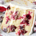 Sparkling Cranberry White Chocolate Bundt Cake slice on white plate