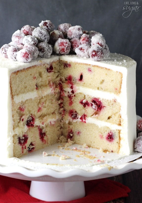 Sparkling Cranberry White Chocolate Cake with a few slices removed