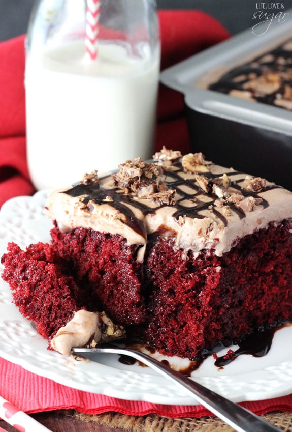 Nutella Red Velvet Poke Cake slice on a plate with a bite on a fork