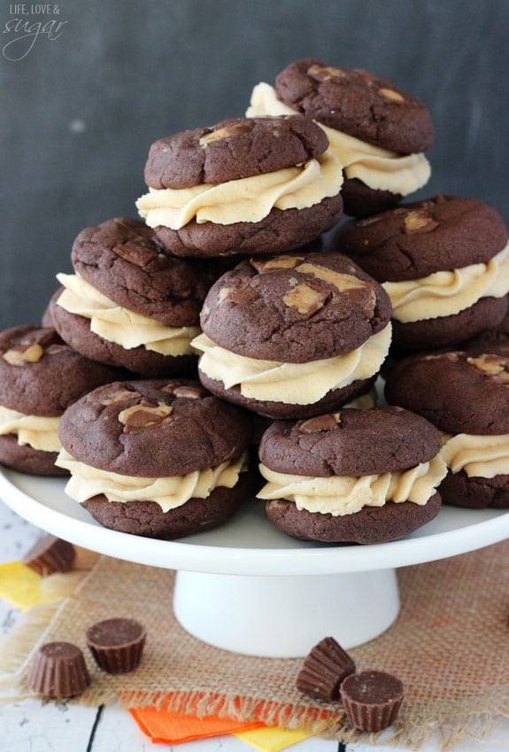 Chocolate Cookie Sandwiches stacked on a white cake stand