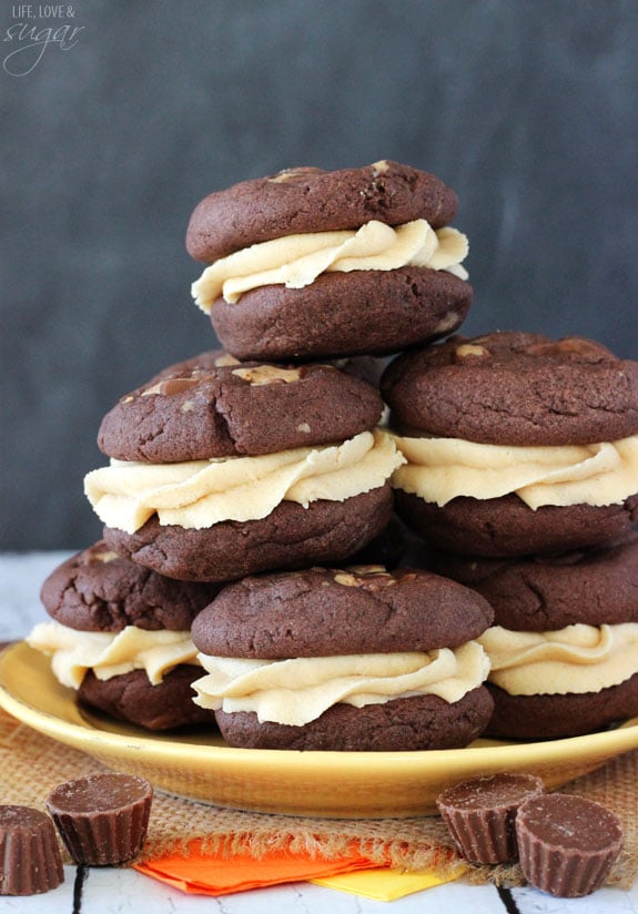 Reese's Chocolate Cookie Sandwiches stacked on gold plate with candy around it
