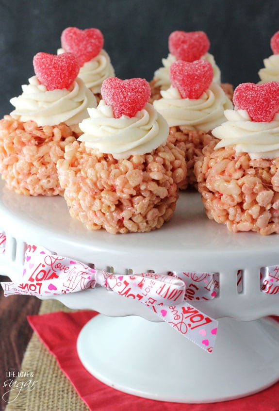 A bunch of Rice Krispie Treat Cupcakes on a white platter with a ribbon