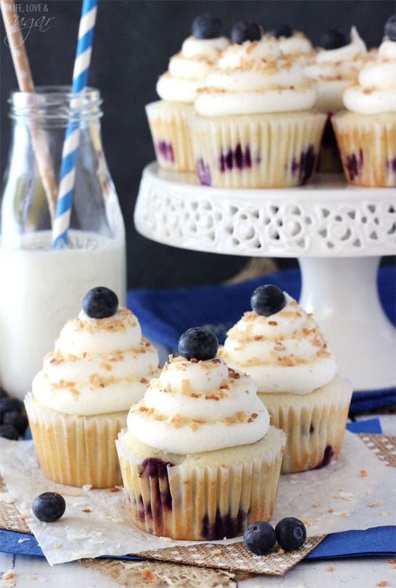 Blueberry Coconut Cupcakes on a napkin and a cake stand