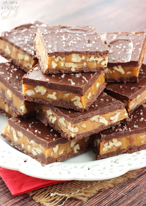 Pecan Caramel Turtle Bars stacked on a white plate
