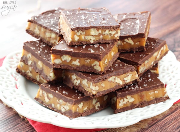 Pecan Caramel Turtle Bars stacked on a white plate