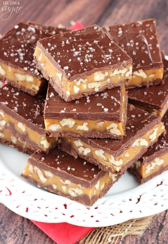 Pecan Caramel Turtle Bars stacked on a white plate