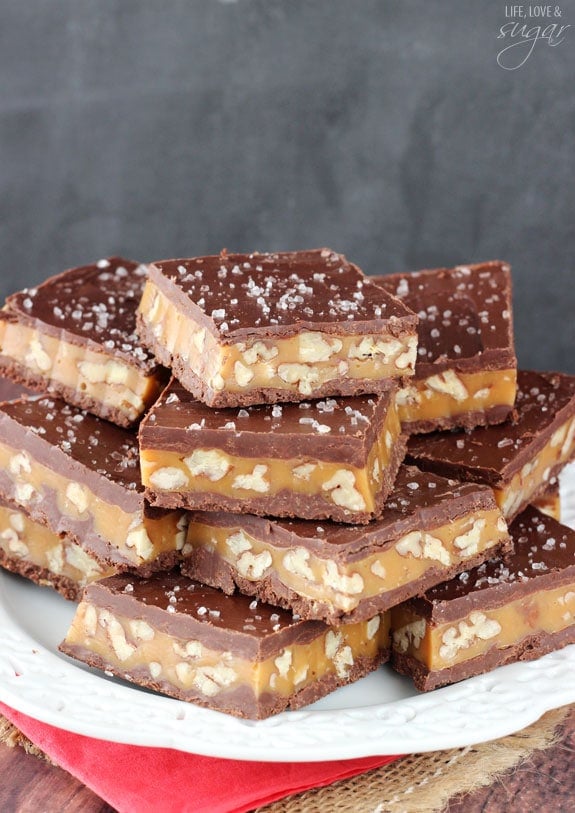 Pecan Caramel Turtle Bars stacked on a white plate