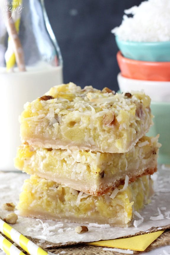 Side view of Pineapple Coconut Bars stacked on a napkin