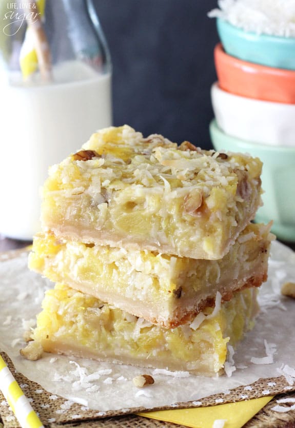 Pineapple Coconut Bars stacked on a napkin