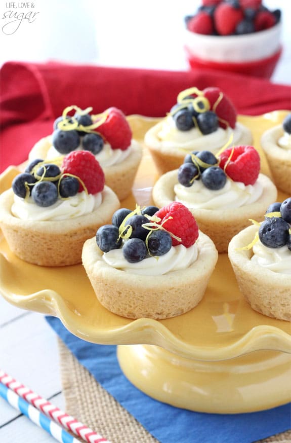 Berry Lemon Cheesecake Cookie Cups on a yellow cake stand