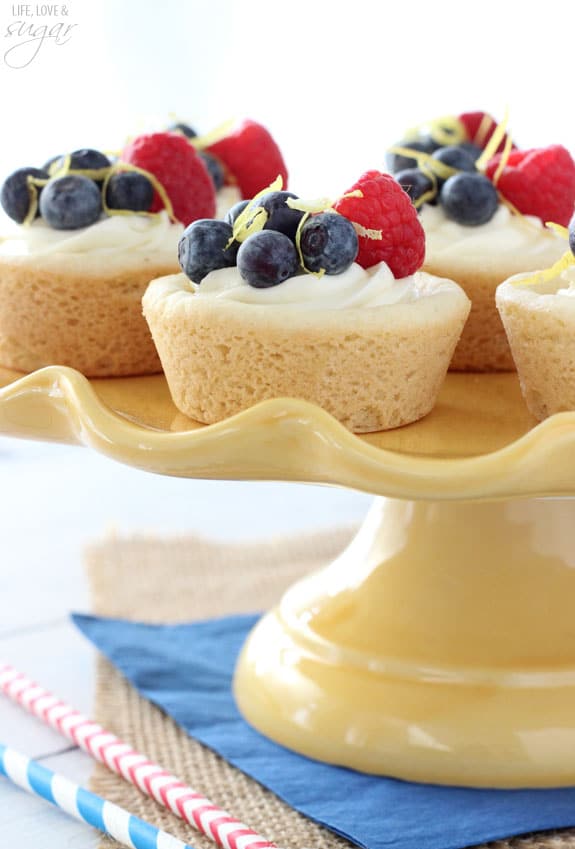 Berry Lemon Cheesecake Cookie Cups on a yellow cake stand