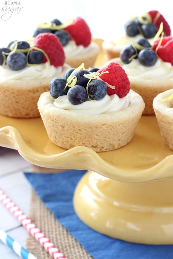 Berry Lemon Cheesecake Cups on a yellow cake stand