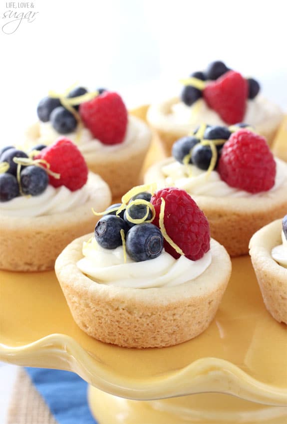 Berry Lemon Cheesecake Cookie Cups on a yellow cake stand
