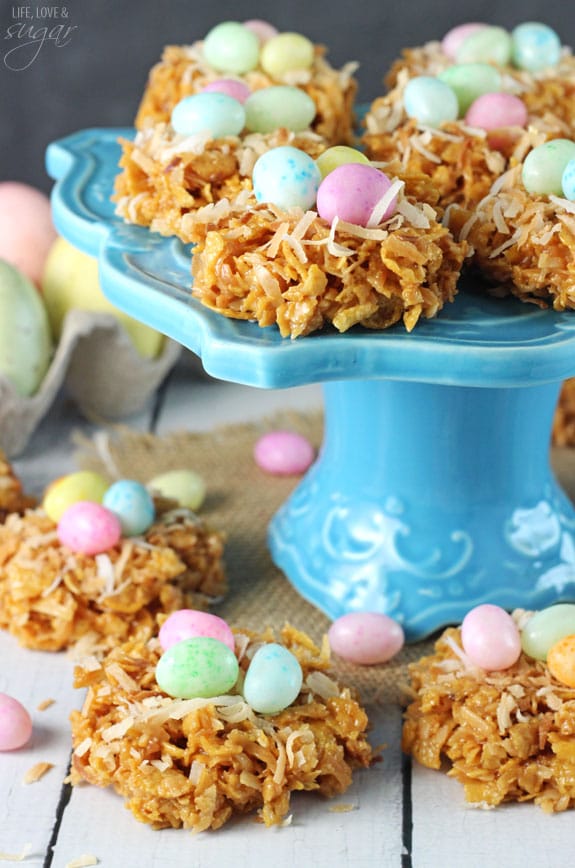No Bake Coconut Caramel Nest Cookies on and around a blue cake stand