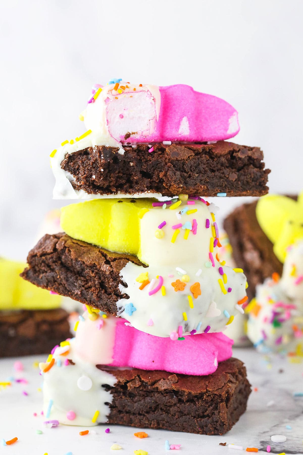 Stack of 3 brownies with a bite taken from the top one