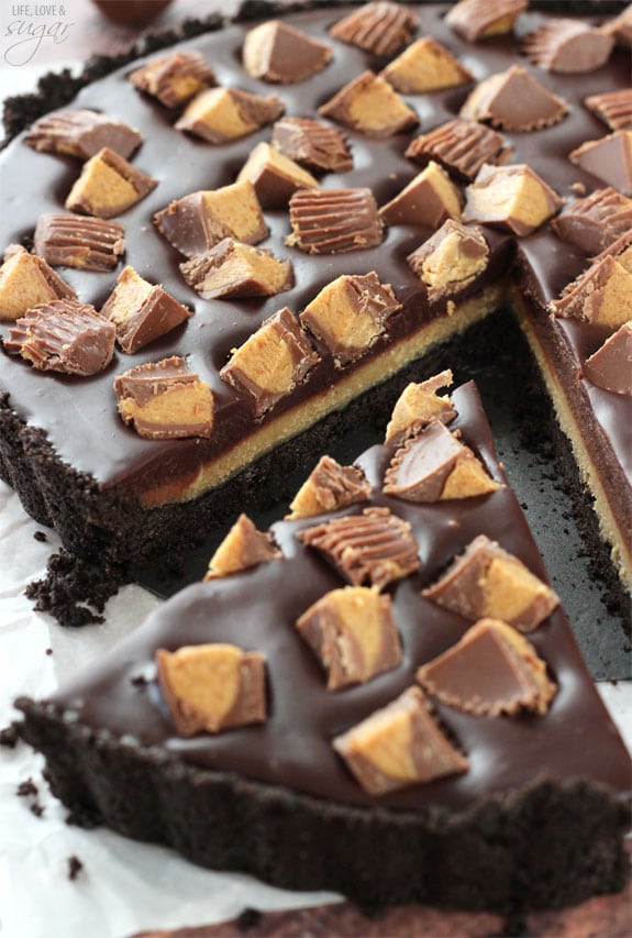 A slice being removed from a Reeses Chocolate Peanut Butter Tart