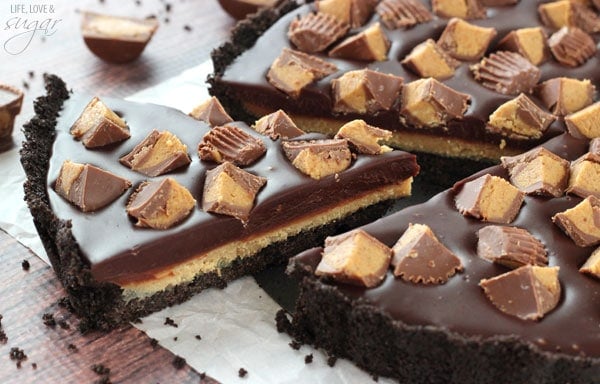 A slice being lifted from a Reeses Chocolate Peanut Butter Tart 