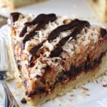 Samoa Cookie Cake slice on white plate