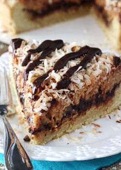 Samoa Cookie Cake slice on white plate