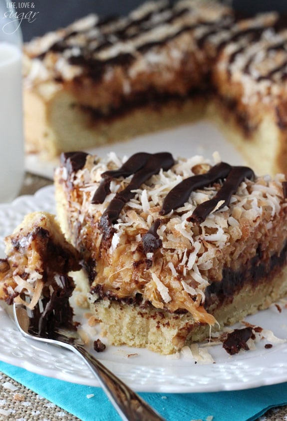 Samoa Cookie Cake slice on a plate with a bite on a fork