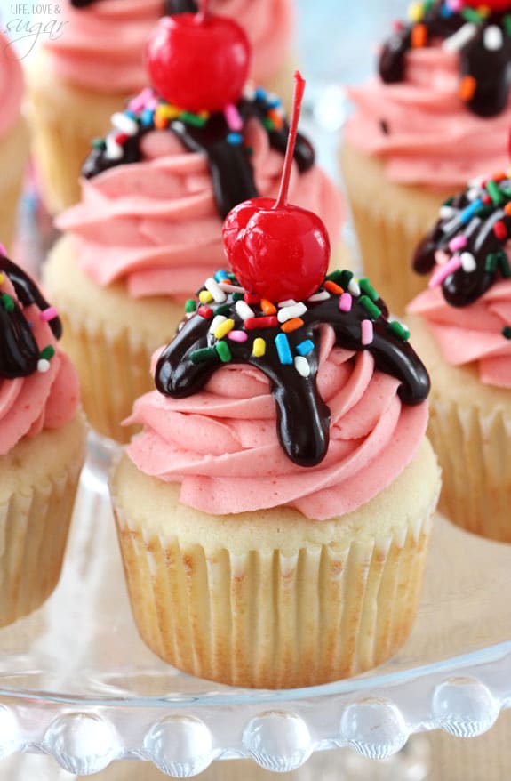 Close-up of Strawberry Sundae Cupcakes on a glass cake stand