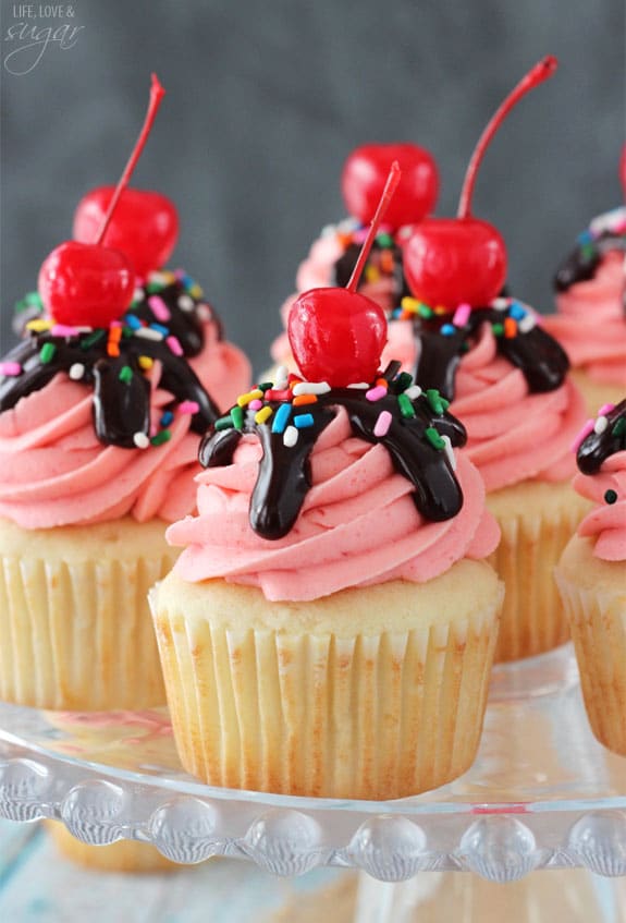 Strawberry Sundae Cupcakes on a glass cake stand