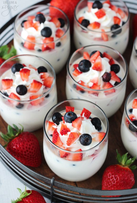Overhead view of Panna Cotta with Fresh Berries in glass cups on a tray