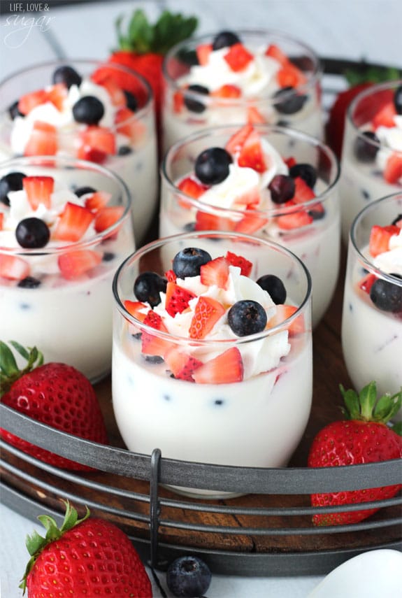 Panna Cotta with Fresh Berries in glass cups on a tray