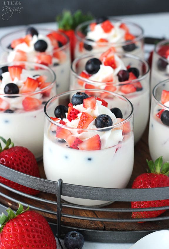 Panna Cotta with Fresh Berries in glass cups on a tray